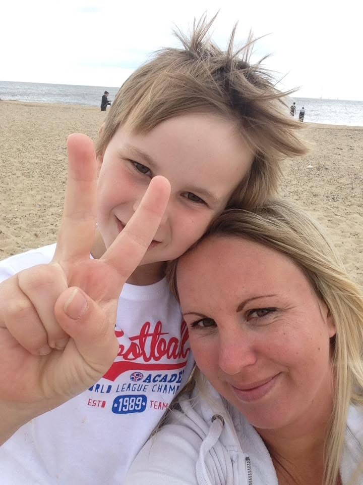 Callum and his mum on the beach, smiling together